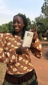 Simpo Gladys holding her brand new Iphone 17 pro max