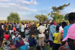 Residents gather at the scene in Aguny Village in Amuru District where the bodies of the two missing children were found
